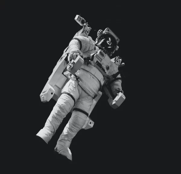 Astronaut in white suit in greyscale photo